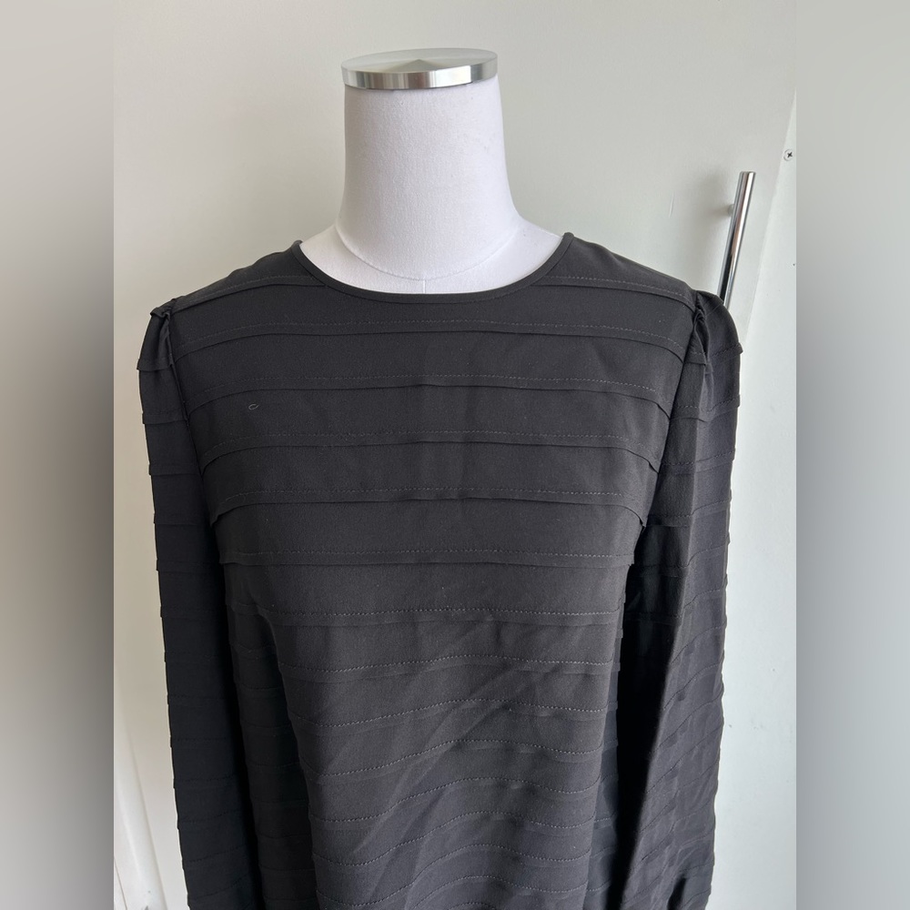 Tory Burch black long sleeved blouse. Line detail w/ 3 button back closure.